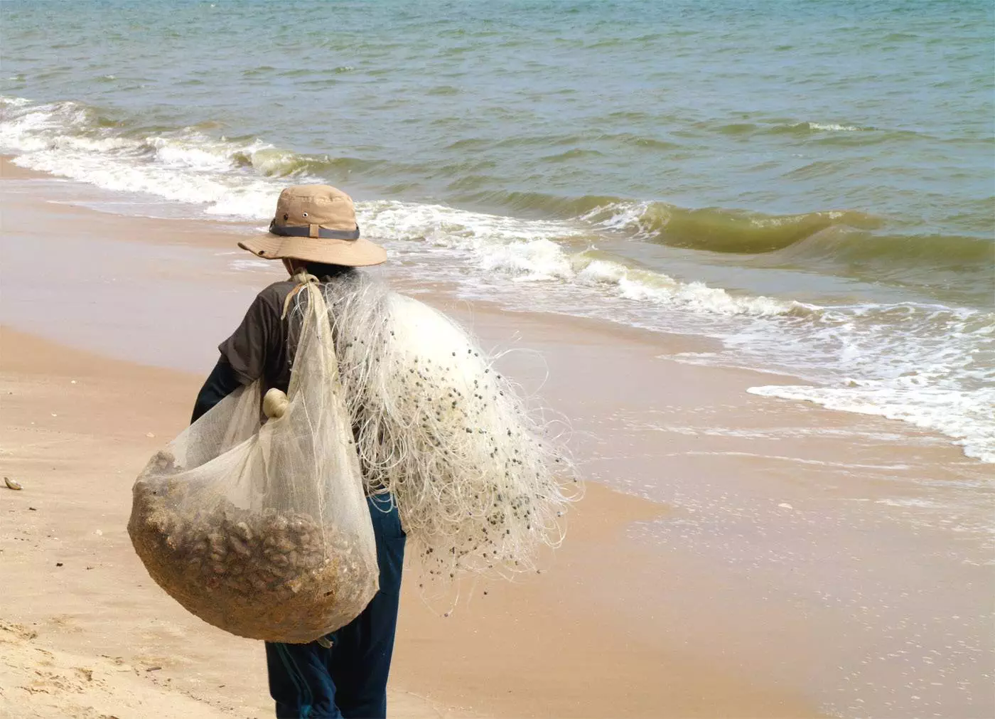 Pescador en la playa de Mui Ne, Vietnam
